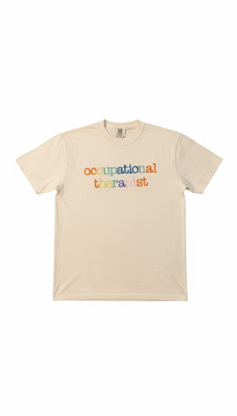 Captain Hawk Designs cream crew-neck t-shirt with vibrant multi-colored embroidered Occupational Therapist text.