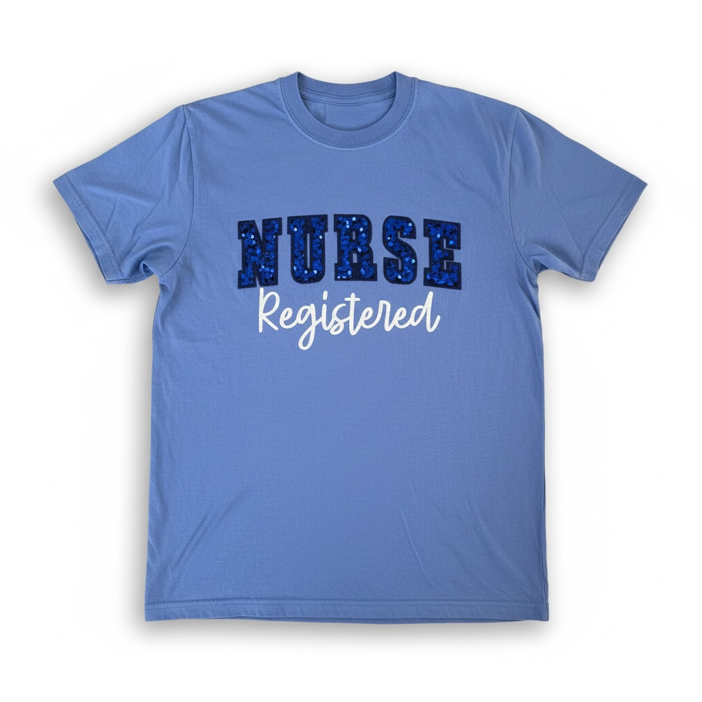 Captain Hawk Designs blue crewneck t-shirt with blue sequin NURSE text and white Registered script for nurses.